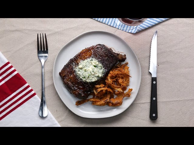 Rib Eye Steak With Blue Cheese Compound Butter And Crispy Onion Strings